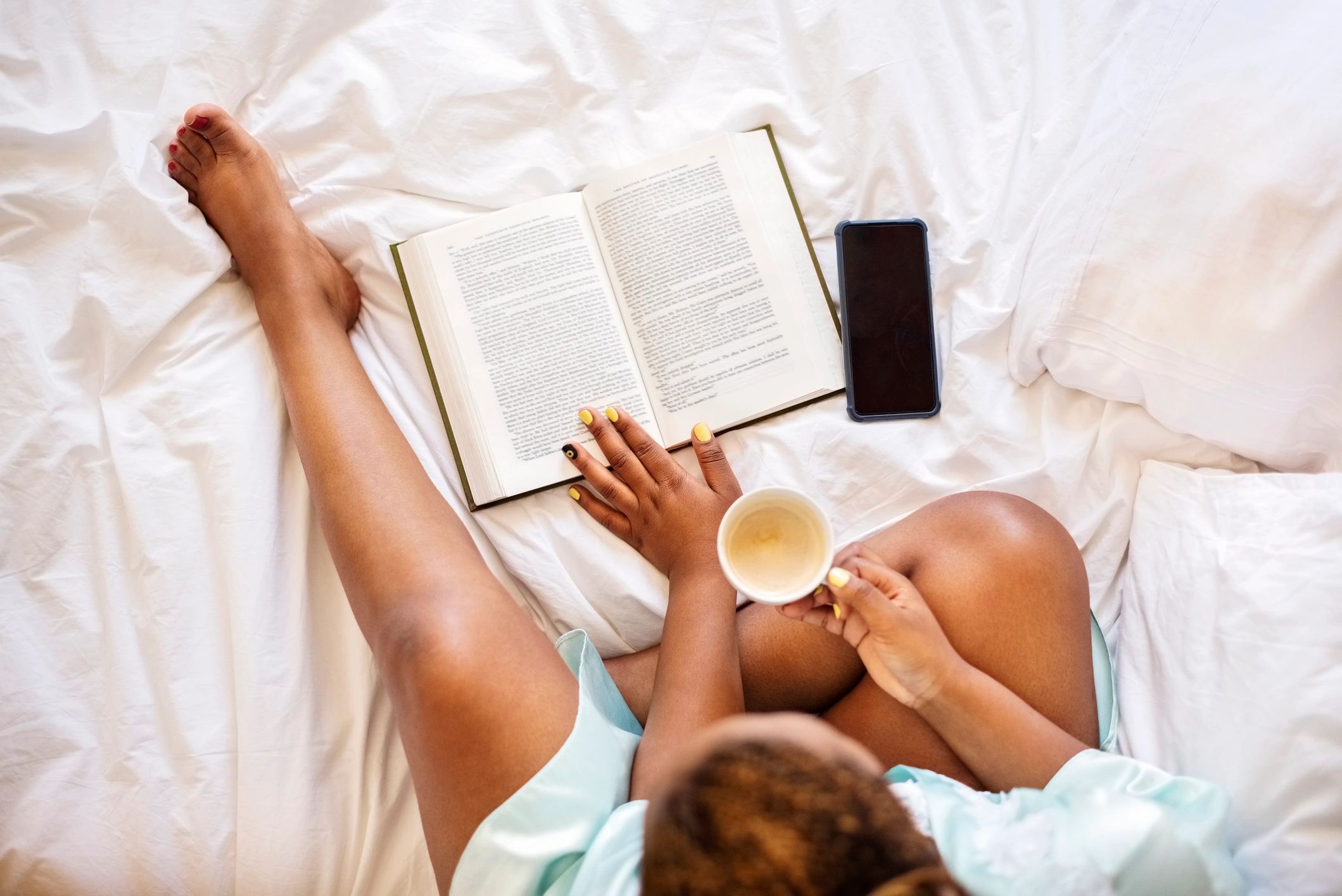 Reader enjoying a book with coffee