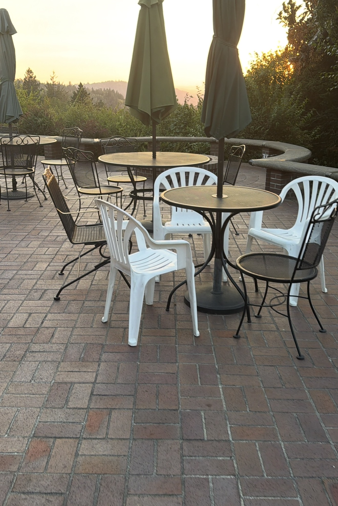 Menucha patio with tables overlooking the trees at sunset